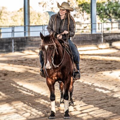 Photo of Simmone Jade Mackinnon while riding on the top of a horse.  I
